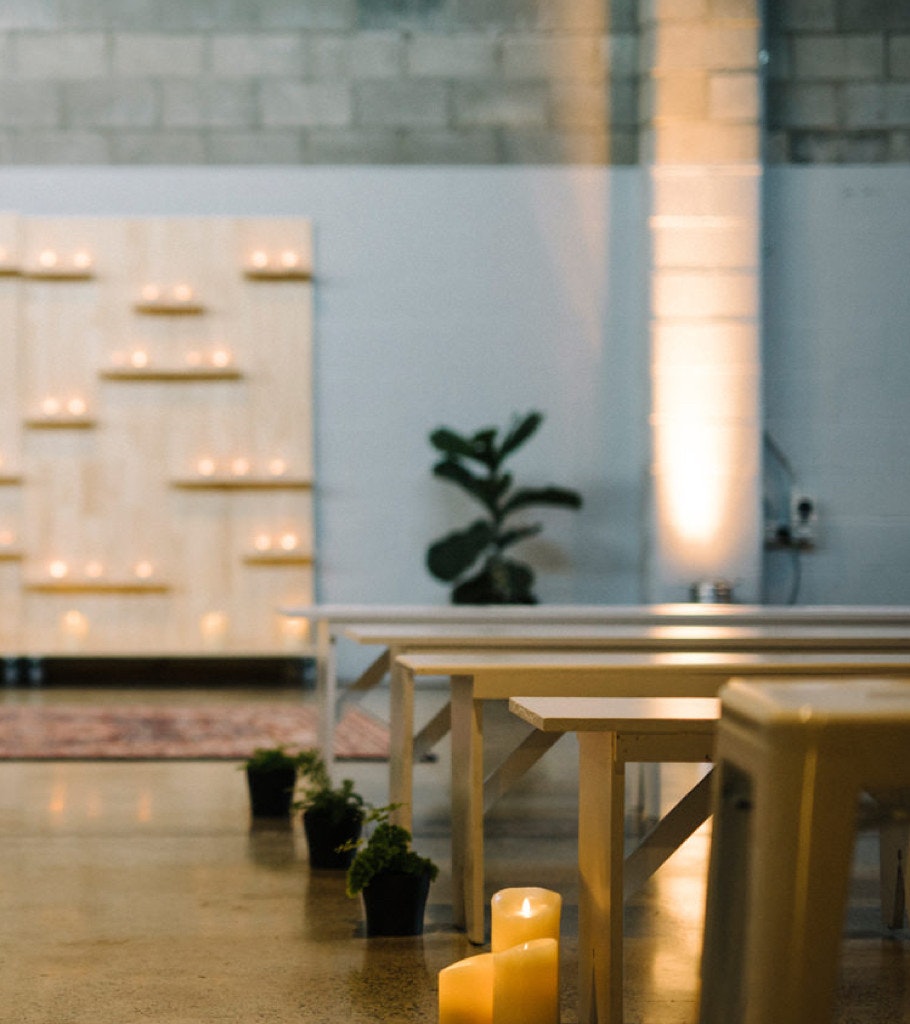 Candlelit detail of a wedding ceremony aisle.